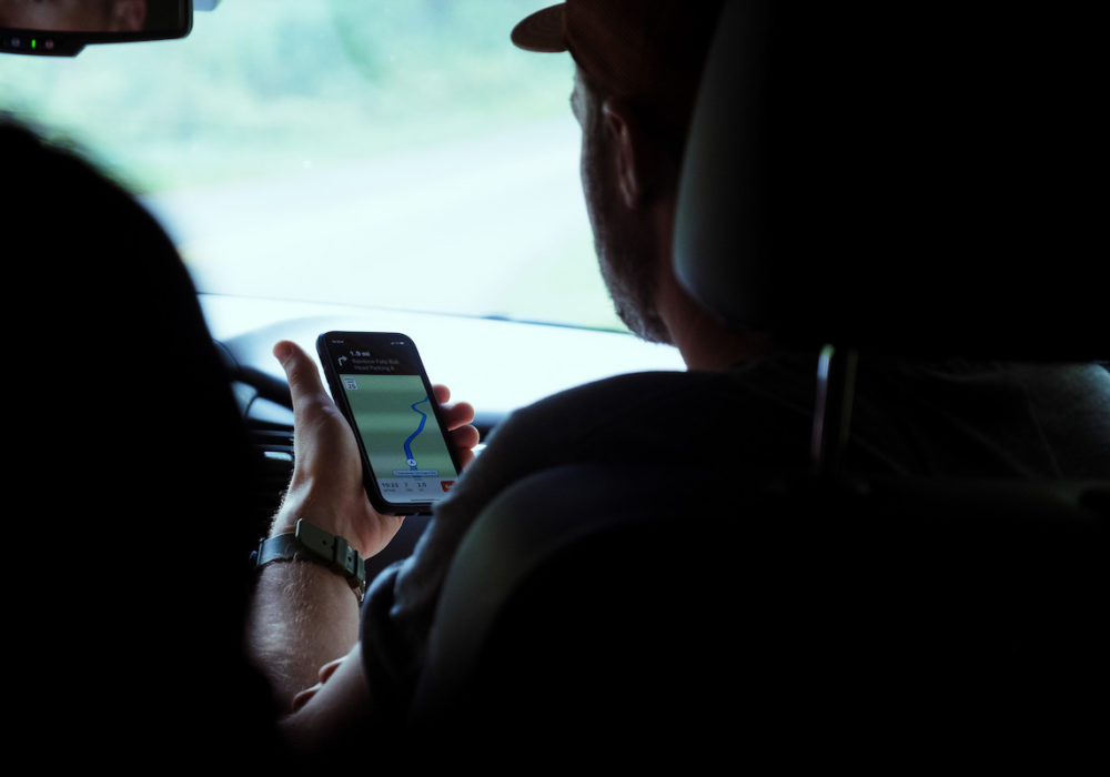 man using smartphone map to navigate driver